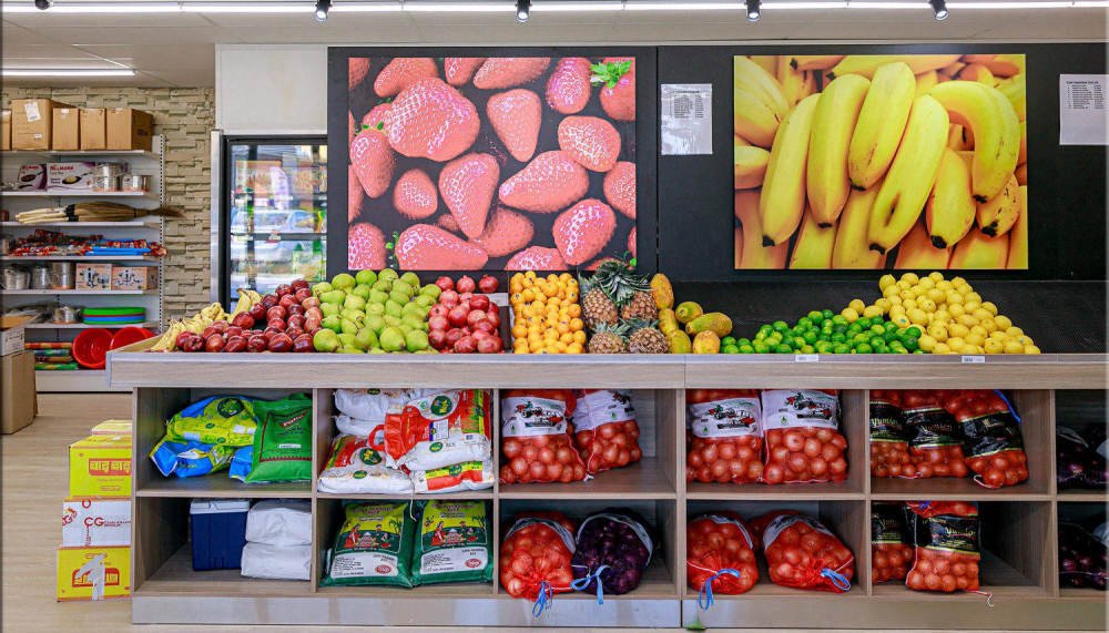 Fresh produce and grocery aisles inside Sangam Indian Supermarket